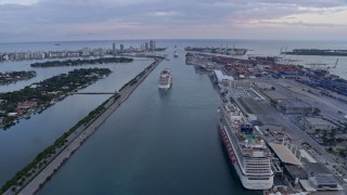 AX0172_167 - 6.7K stock footage aerial video of cruise ships sailing out of Biscayne Bay at sunset, Miami, Florida