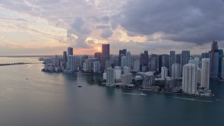 AX0172_168 - 6.7K aerial stock footage tilt from the bay and approach the Downtown Miami skyline and Brickell Key, Florida at sunset