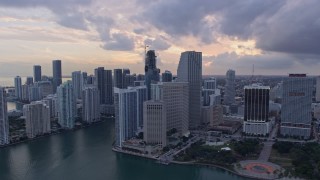 AX0172_175 - 6.7K aerial stock footage of passing tall skyscrapers, reveal the river and Brickell Key in Downtown Miami, Florida at sunset