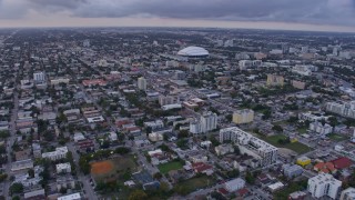 AX0172_177 - 6.7K stock footage aerial video fly over Little Havana neighborhood to approach stadium at sunset, Miami, Florida