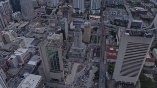 AX0172_183 - 6.7K aerial stock footage reverse view of courthouse and high-rise apartment buildings at sunset, Miami, Florida