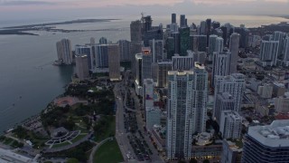 AX0172_191 - 6.7K stock footage aerial video flyby skyscrapers in Downtown Miami and reveal waterfront park at sunset, Miami, Florida