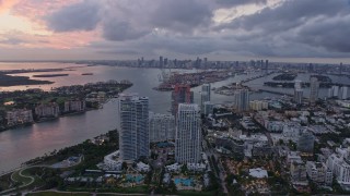 AX0172_196 - 6.7K stock footage aerial video flyby South Beach at sunset, with view or the port and Downtown Miami, Florida