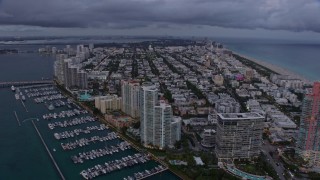 AX0172_197 - 6.7K aerial stock footage flyby South Beach high-rises and neighborhood at sunset, Miami, Florida