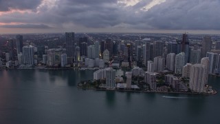 AX0172_199 - 6.7K stock footage aerial video fly over Biscayne Bay to approach Downtown Miami skyline at twilight, Florida