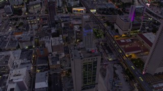 AX0172_205 - 6.7K aerial stock footage tilt to and approach the courthouse in Downtown Miami at twilight, Florida