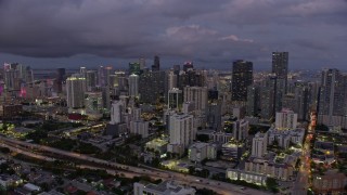 AX0172_212 - 6.7K aerial stock footage of approaching and flying over skyscrapers in Downtown Miami at twilight, Florida