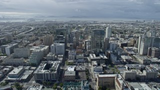 AX0173_0008 - 6K aerial stock footage of flying over Tribune Tower in Downtown Oakland toward urban neighborhoods, California