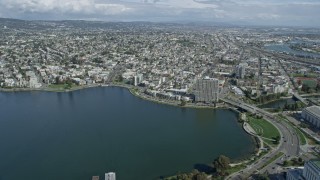AX0173_0011 - 6K aerial stock footage of flying over Lake Merritt toward urban neighborhoods, Oakland, California
