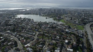 AX0173_0013 - 6K stock footage aerial video of approach Lake Merritt and downtown from urban neighborhoods, Oakland, California