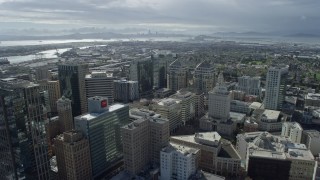 AX0173_0016 - 6K stock footage aerial video fly over downtown office buildings toward Port of Oakland, California
