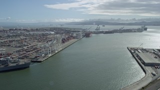 AX0173_0028 - 6K aerial stock footage of cargo cranes and containers at the Port of Oakland, California