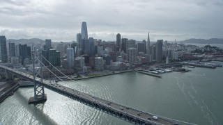 AX0173_0046 - 6K stock footage aerial video fly over Bay Bridge toward the city's skyline, Downtown San Francisco, California