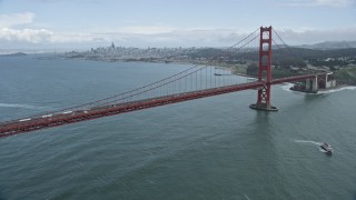 AX0173_0057 - 6K aerial stock footage of flying by the iconic Golden Gate Bridge, the city's skyline in the background, San Francisco, California