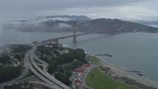 AX0173_0096 - 6K aerial stock footage fly through a fog bank to reveal the Golden Gate Bridge, California
