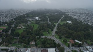AX0173_0121 - 6K aerial stock footage of flying by Golden Gate Park under a fog bank, San Francisco, California