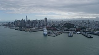 AX0173_0128 - 6K aerial stock footage flyby North Beach piers with view of Downtown San Francisco skyline, California