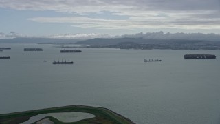 AX0173_0132 - 6K aerial stock footage of a wide view of cargo ships in San Francisco Bay, California