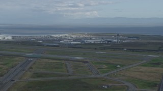 AX0173_0136 - 6K aerial stock footage a wide view of runways and hangars at Oakland Airport, California