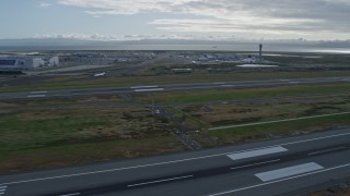 AX0173_0138 - 6K aerial stock footage of descending past runways at Oakland Airport, California
