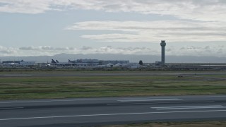 AX0173_0139 - 6K aerial stock footage of control tower and runways at Oakland Airport, California