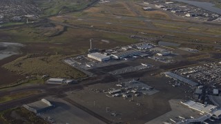 AX0174_0003 - 6K aerial stock footage of a reverse view of the control tower and runways at Oakland Airport, California