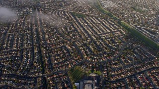 AX0174_0011 - 6K aerial stock footage of tilting to a bird's eye view of suburban neighborhoods in Union City, California