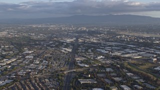 AX0174_0020 - 6K stock footage aerial video of tilting from the 880 freeway in Milpitas to reveal Downtown San Jose in the distance, California