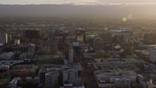 AX0174_0025 - 6K aerial stock footage of office buildings in Downtown San Jose at sunset, California