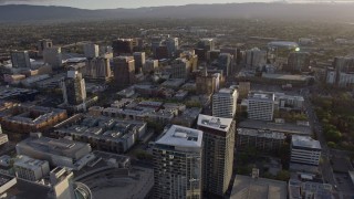 AX0174_0026 - 6K aerial stock footage of office and apartment buildings in Downtown San Jose at sunset, California