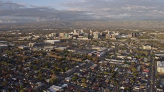 AX0174_0037 - 6K aerial stock footage of approaching Downtown San Jose at sunset, California