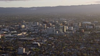 AX0174_0040 - 6K aerial stock footage of a view of city buildings in Downtown San Jose at sunset, California