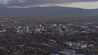 AX0174_0042 - 6K aerial stock footage of a reverse view of city buildings in Downtown San Jose at sunset, California