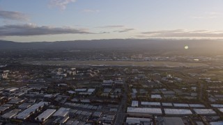 AX0174_0043 - 6K aerial stock footage of a wide view of San Jose International Airport at sunset, California