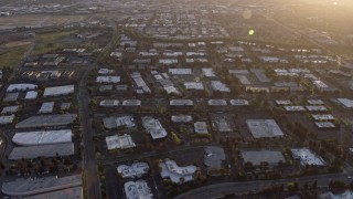 AX0174_0044 - 6K aerial stock footage of warehouse and office buildings at sunset, San Jose, California
