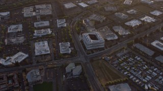 AX0174_0045 - 6K aerial stock footage approach and orbit Samsung corporate office building at sunset, San Jose, California