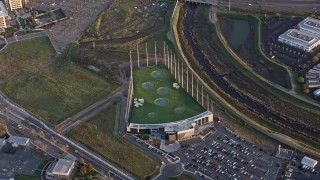 AX0174_0047 - 6K aerial stock footage of a Topgolf course in San Jose at sunset, California