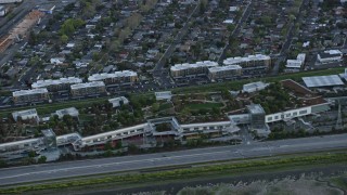 AX0174_0053 - 6K aerial stock footage of Facebook corporate offices at sunset, Menlo Park, California