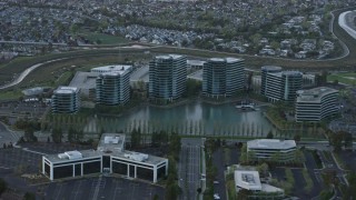 AX0174_0059 - 6K aerial stock footage of the Oracle office building complex at sunset, Redwood City, California