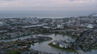 AX0174_0060 - 6K aerial stock footage of office buildings near the San Mateo Bridge at sunset, Foster City, California