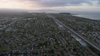 AX0174_0061 - 6K aerial stock footage of flying over San Mateo suburban neighborhoods at sunset, California