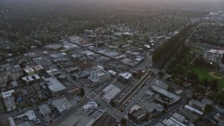 AX0174_0064 - 6K aerial stock footage of flying over shops and office buildings at sunset, Burlingame, California