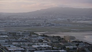 AX0174_0065 - 6K aerial stock footage of San Francisco International Airport at sunset, California