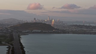 AX0174_0070 - 6K stock footage aerial video of the San Francisco skyline seen from Bayview Park at sunset, California
