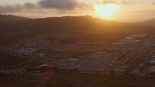 AX0174_0074 - 6K aerial stock footage flyby suburban neighborhood around the Cow Palace at sunset, Daly City, California