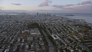 AX0174_0077 - 6K stock footage aerial video of following 101 freeway toward the distant San Francisco skyline at sunset, California