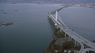 AX0174_0085 - 6K aerial stock footage flying by the Bay Bridge at sunset, California