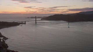 AX0174_0094 - 6K aerial stock footage of flying over Marina District toward the Golden Gate Bridge and setting sun, San Francisco, California