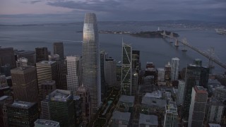 AX0174_0101 - 6K stock footage aerial video orbit Salesforce Tower in Downtown San Francisco at twilight, California