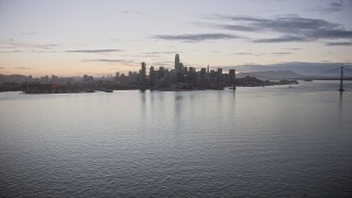 AX0174_0102 - 6K stock footage aerial video of a wide view of the Downtown San Francisco skyline from the bay at twilight, California